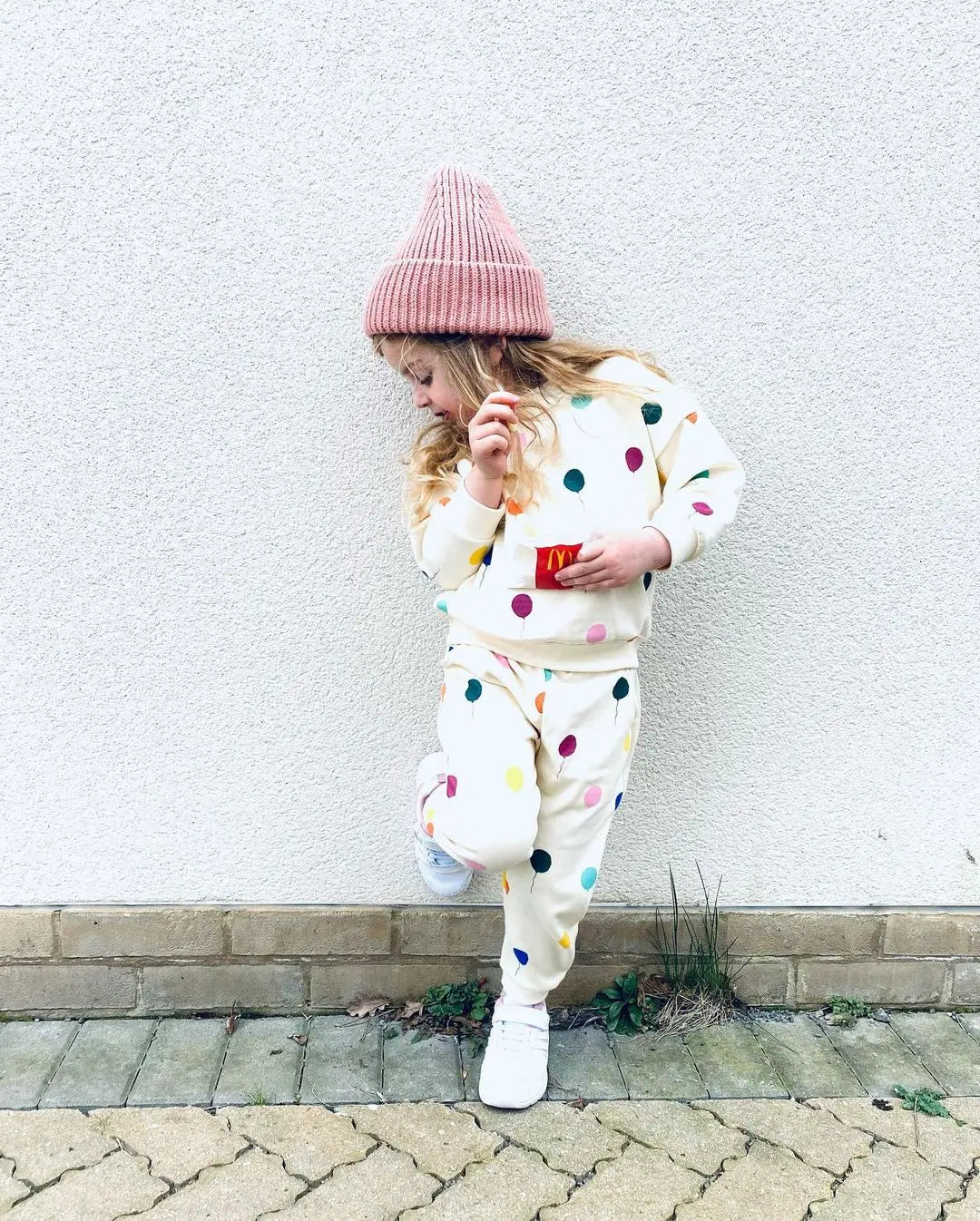 Back view of a childrens apparel matching set: hooded cotton sweater and pants