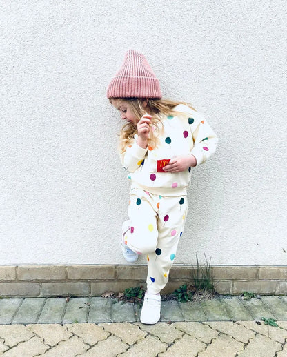 Back view of a childrens apparel matching set: hooded cotton sweater and pants