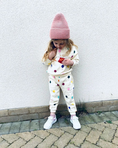 Unisex long-sleeve hooded cotton sweater and pants set, laid flat to show design