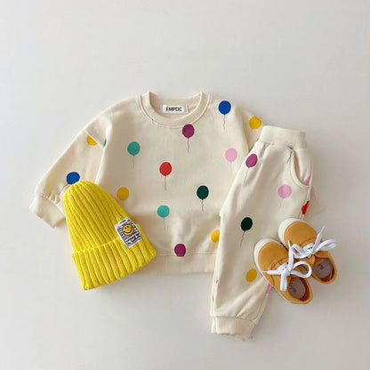 Detail of a hooded cotton sweater from a kids matching set, showing hood and cuffs