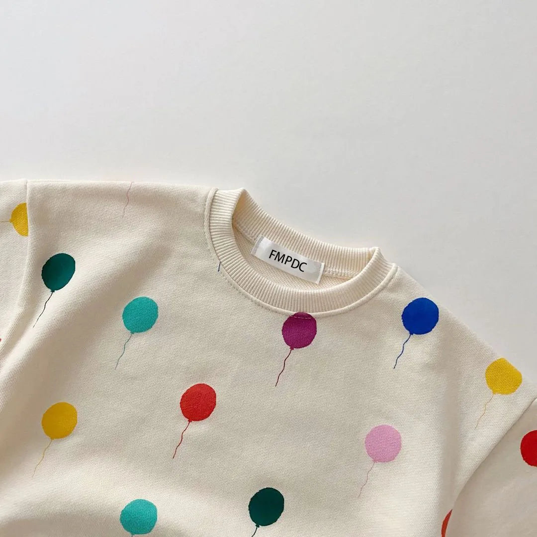Folded unisex kids hooded cotton sweater and pants set, ready for gifting