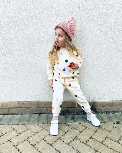 Side view of a child in a long-sleeve hooded cotton outfit, ideal for everyday wear