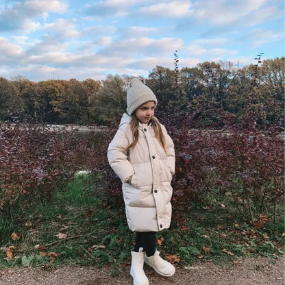 Baby outerwear: a unisex long padded jacket with hood, designed for toddler comfort.