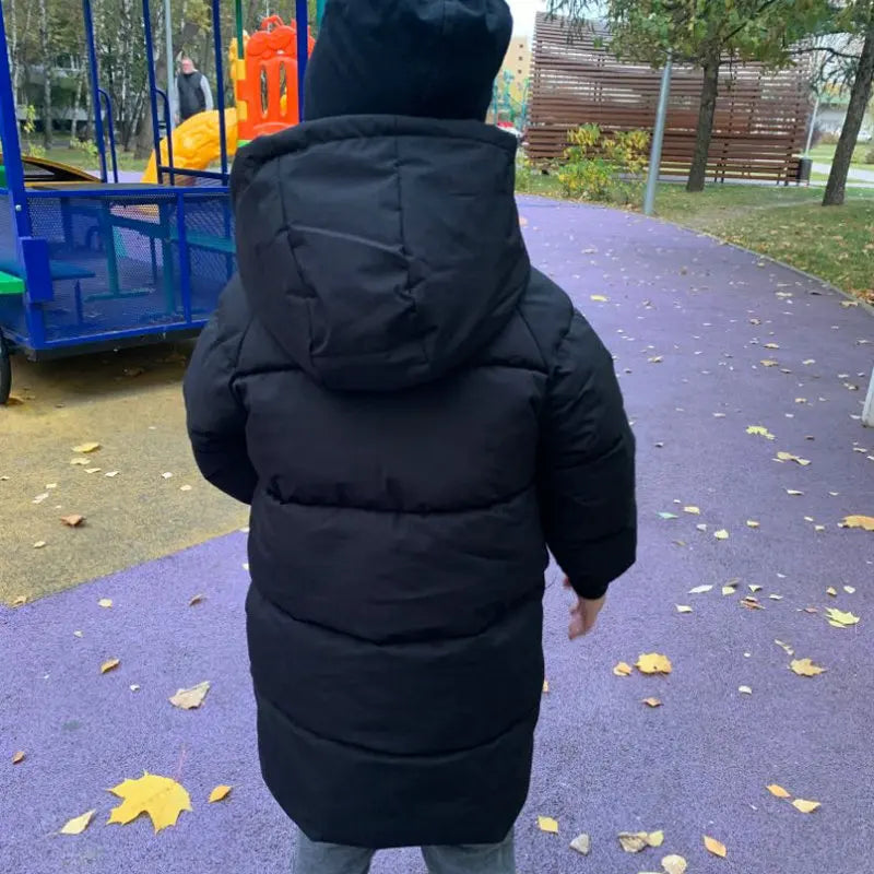 Close-up of the soft hood lining on a unisex kids' padded long winter jacket.