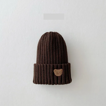 Unisex baby accessory: warm knitted beanie hat with a detailed bear embroidery, winter essential.