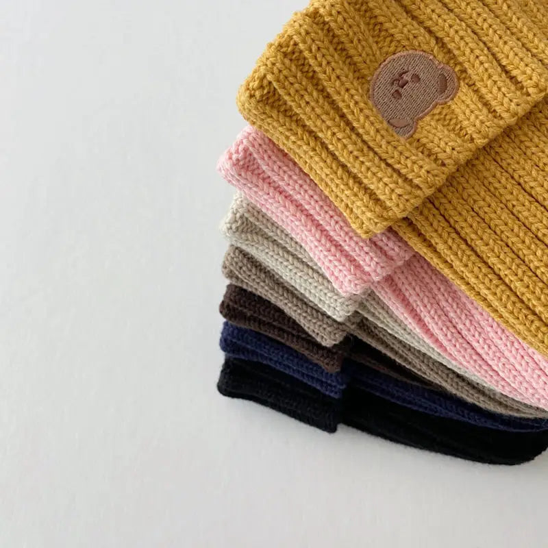 Close-up of a cozy knitted bear embroidery beanie hat for babies, unisex design, perfect for winter fashion.