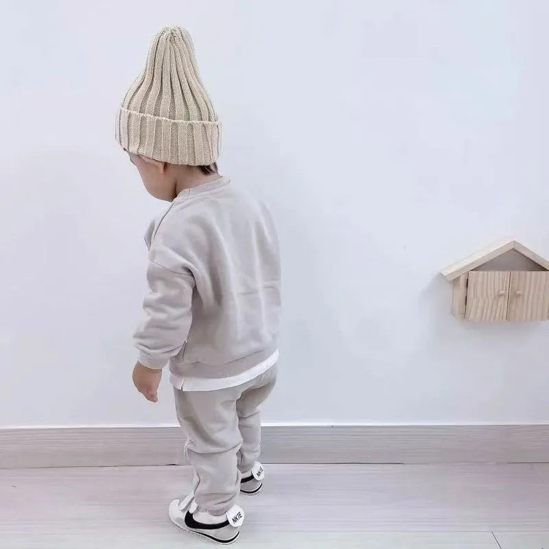 Front view of a warm knitted kids beanie hat, showcasing a playful bear embroidery, comfortable cotton.