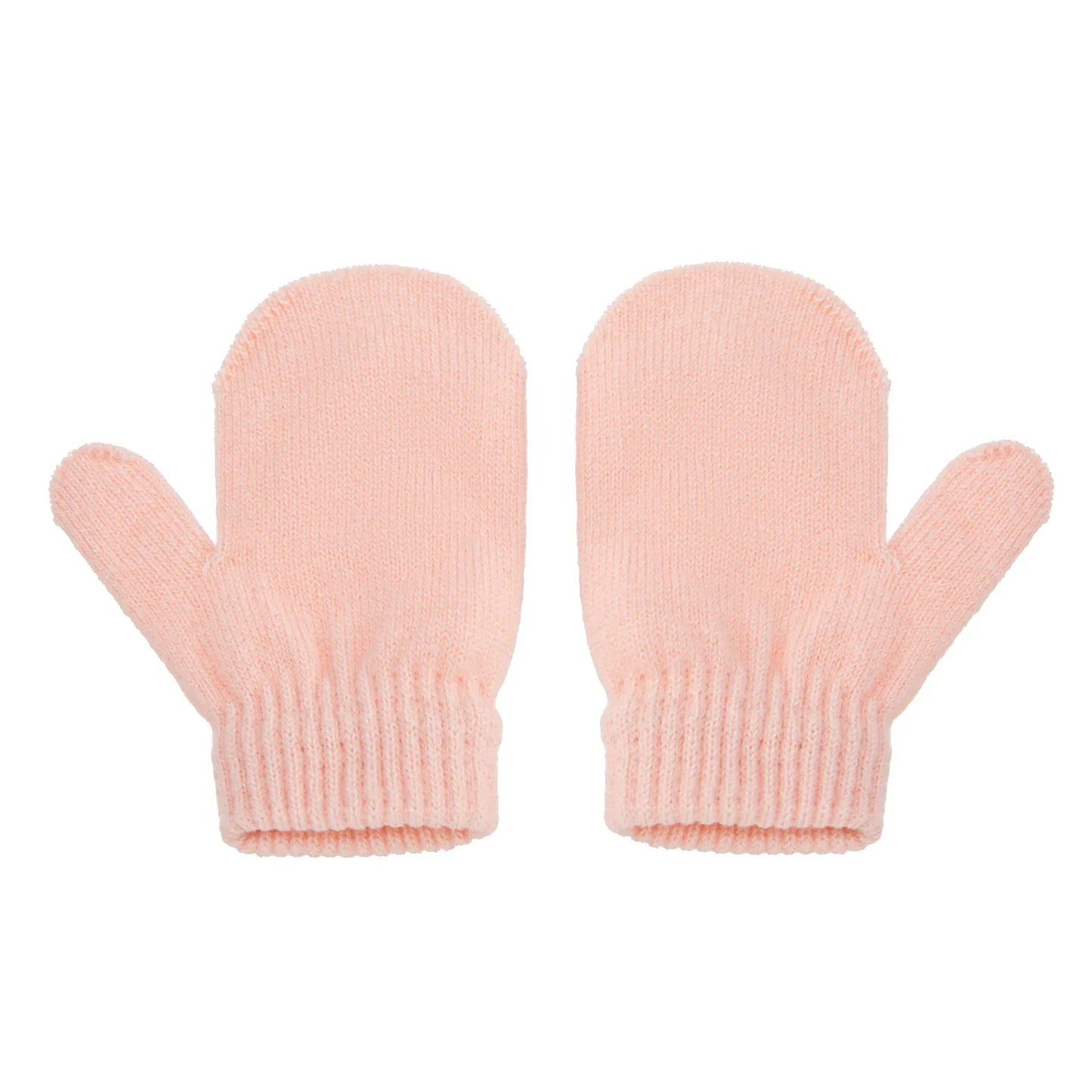 Close-up of a knitted pompom winter hat and gloves set, showing texture and detail