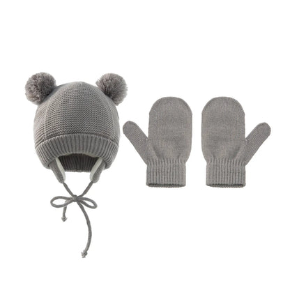 Various colors of unisex kids knitted pompom winter hat & gloves sets displayed together