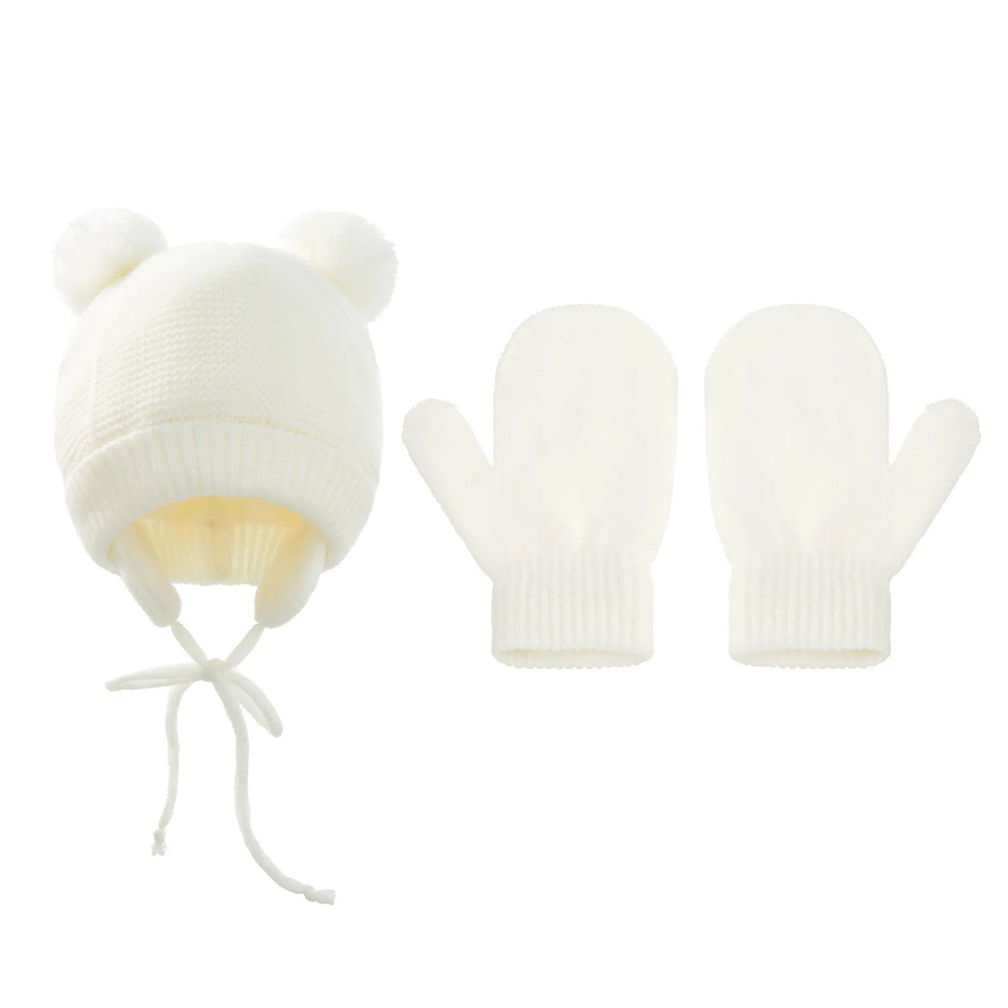 Child wearing a knitted pompom hat and gloves set, ready for cold weather outdoor play