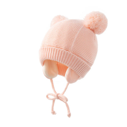 Toddler's red knitted pompom hat and gloves, ideal for keeping warm in cold weather