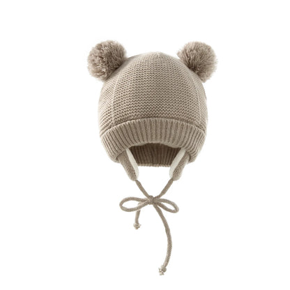 Bright yellow knitted pompom winter hat and gloves, a cheerful accessory for cold weather