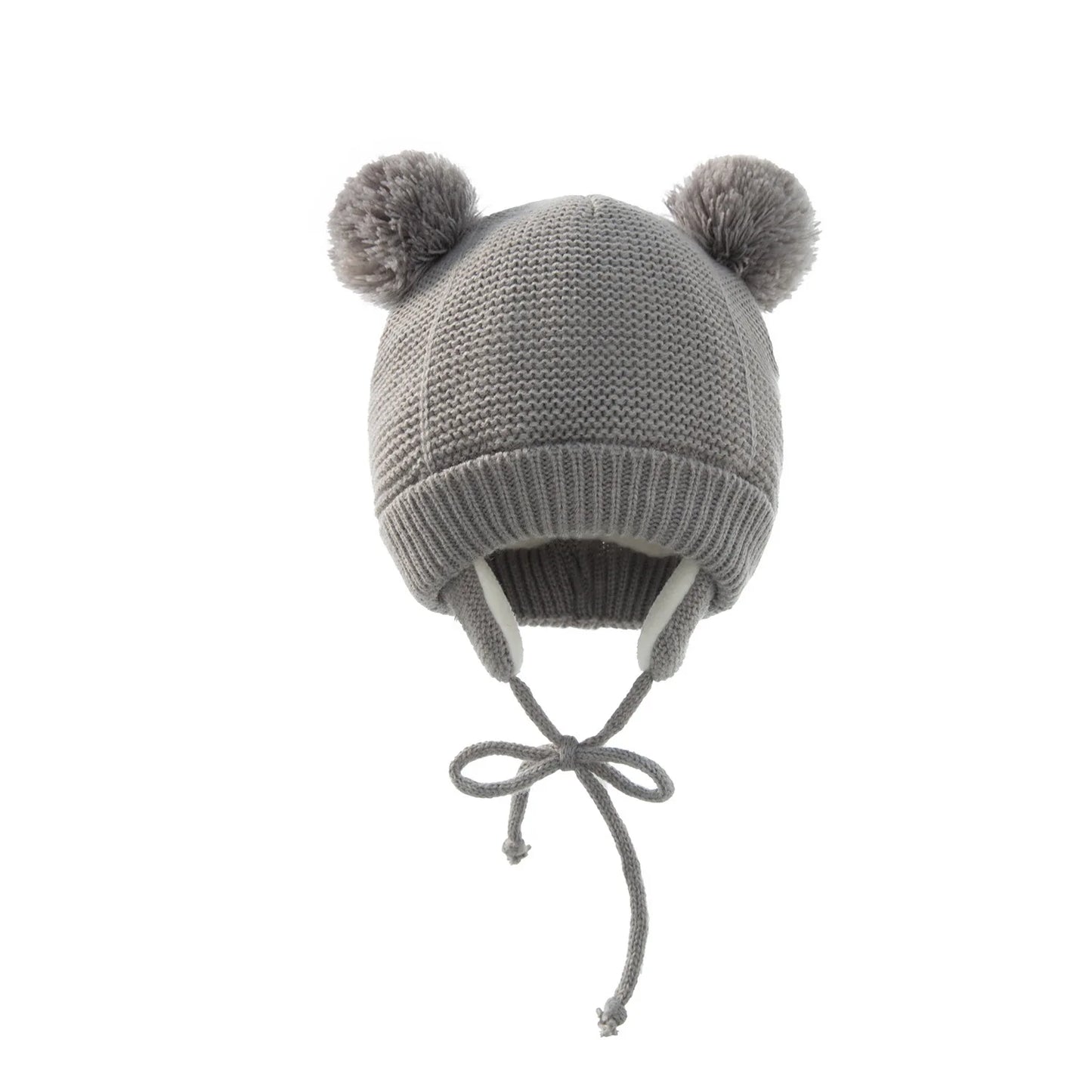 Green knitted pompom baby hat and coordinating gloves, perfect for outdoor winter play