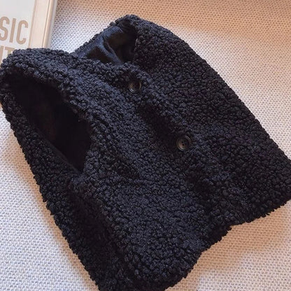 Close-up of button closure on a lamb wool vest, secure and warm baby outerwear