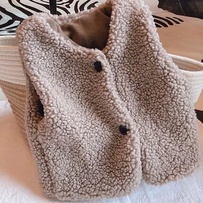 Lamb wool fibers highlighted on a kids vest, premium winter outerwear material
