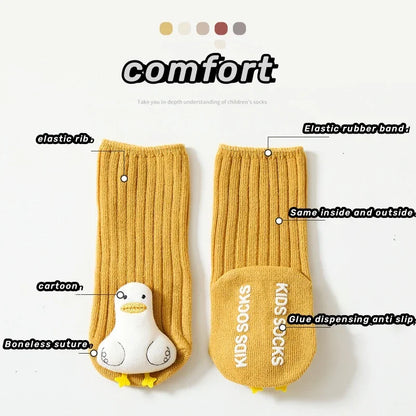Close-up of a pair of yellow non-slip toddler socks with anti-skid grips, made from soft cotton for infant apparel.