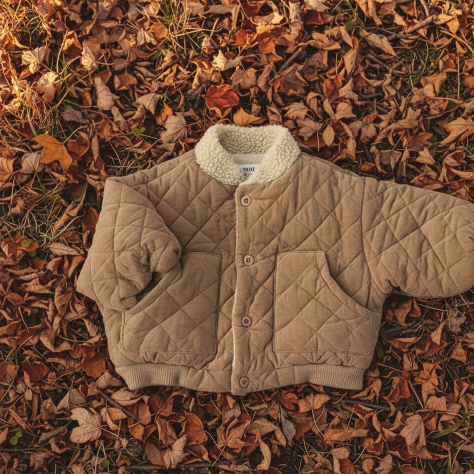 Side view of a kids' checkered jacket, highlighting the quilted detailing and fleece lining