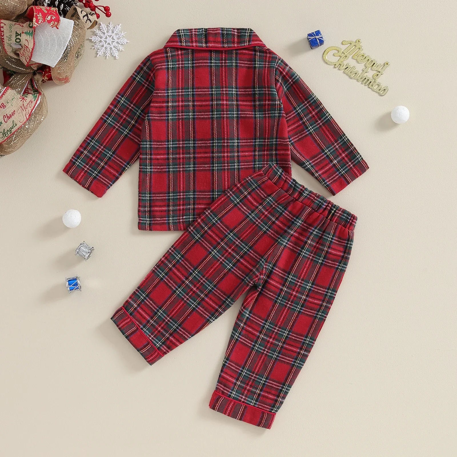 Adorable toddler wearing unisex red plaid Christmas PJs, cozy and cute holiday sleepwear