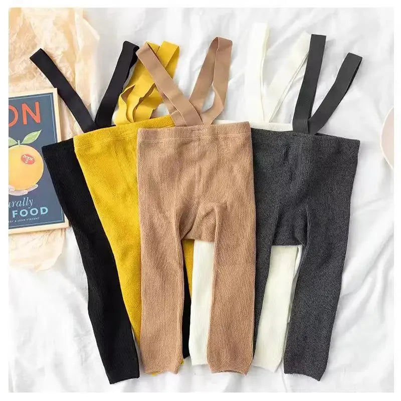 Baby in comfortable cotton leggings with suspenders, ideal for playtime and daily wear