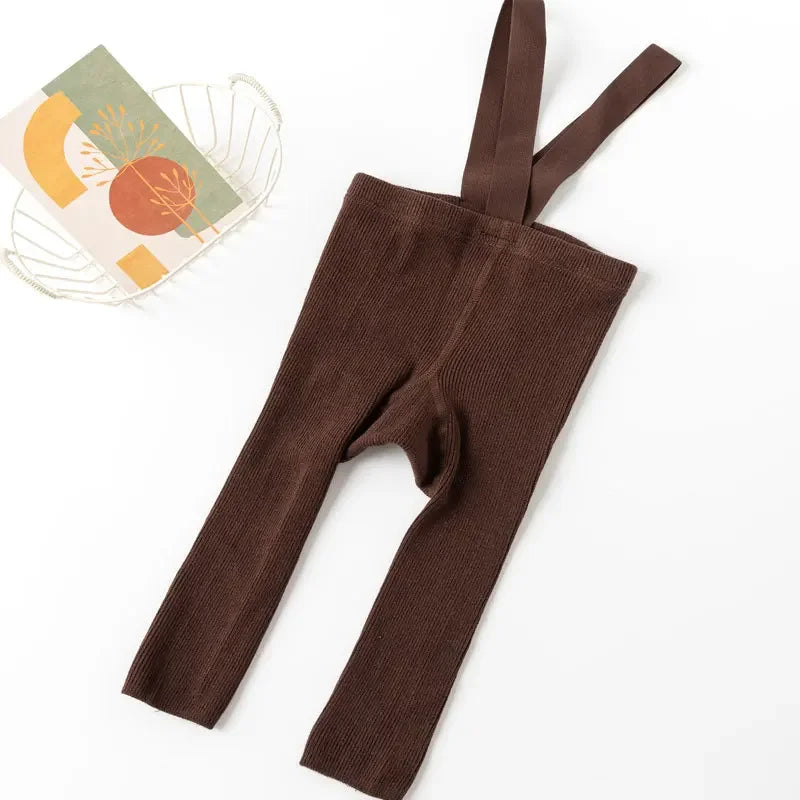 Happy baby crawling in comfy cotton leggings with suspenders, enabling free movement