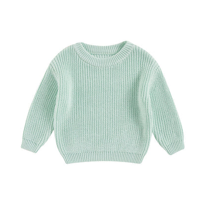 Stack of colorful unisex knit cotton long sleeve sweaters for kids and toddlers.