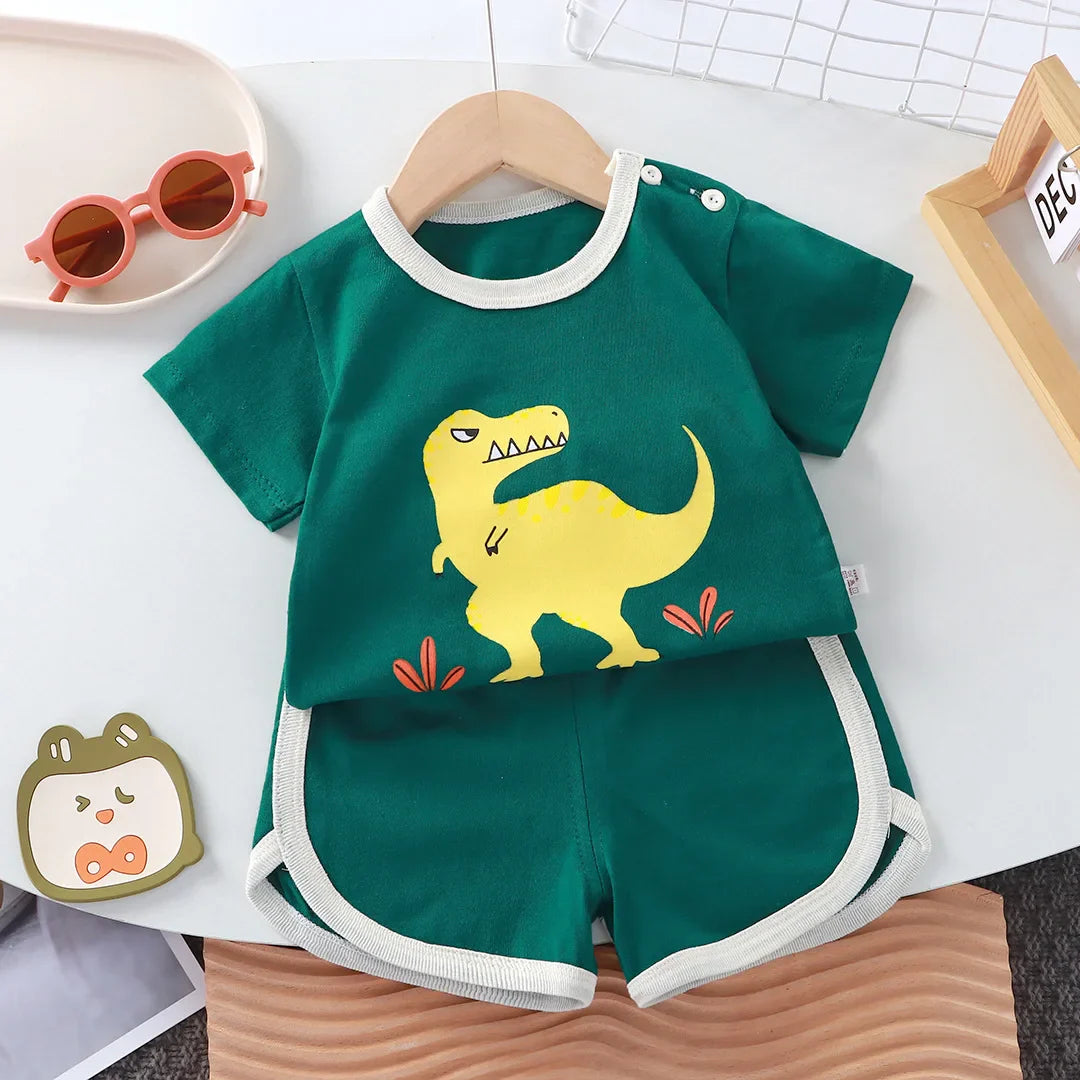 Diverse group of happy children playing outdoors, all wearing the unisex kids' summer cartoon cotton t-shirt and shorts set