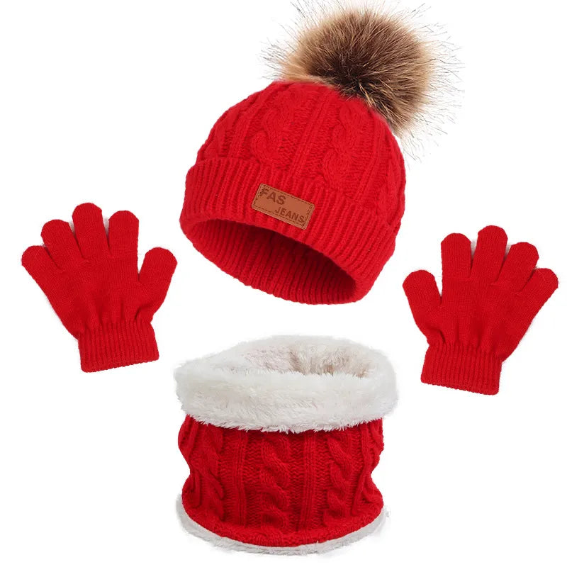 Knitted baby accessories: close-up of the beanie hat, scarf, and gloves texture.