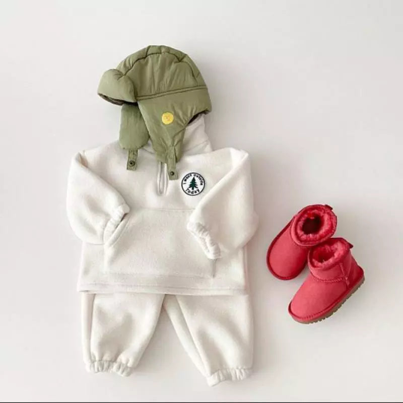 Toddler boy wearing a warm gray knit sweater and pants set, perfect for indoor play.
