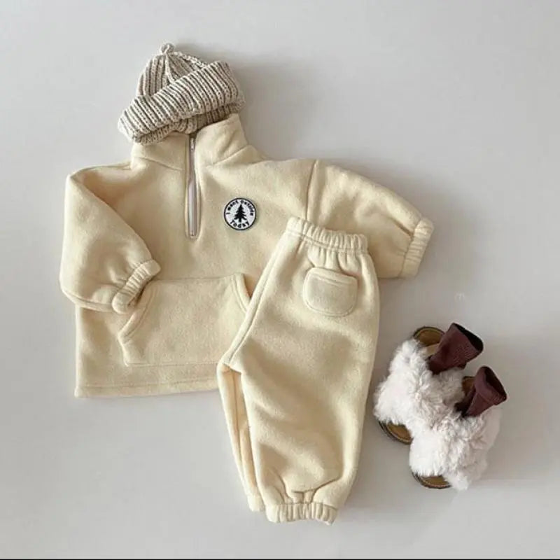 Toddler girl in a cozy unisex knit winter outfit: sweater and matching pants.