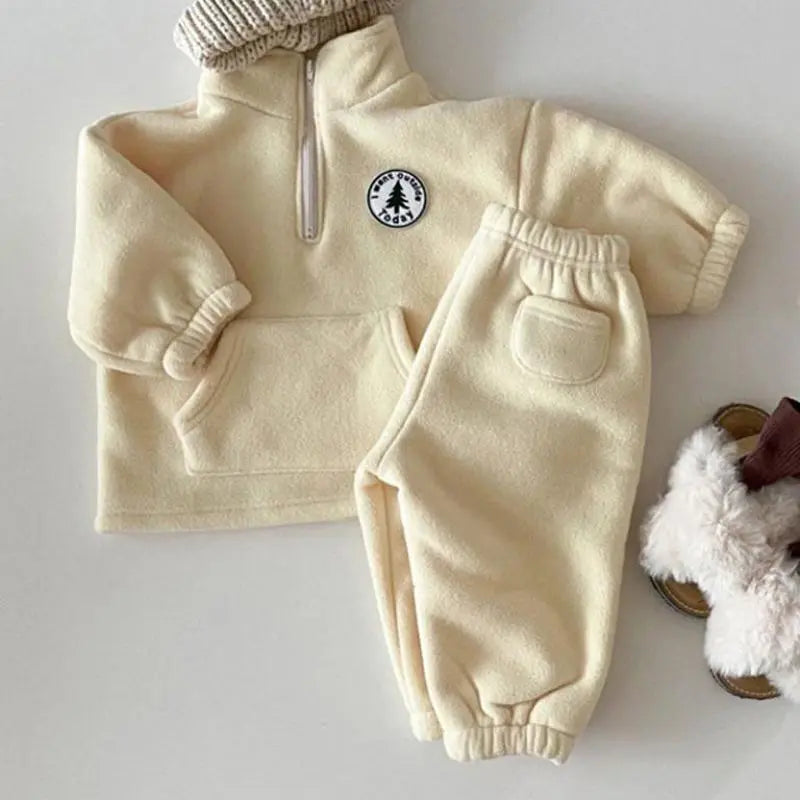 Toddler in a comfortable unisex knit set, long sleeve turtleneck sweater & matching pants.
