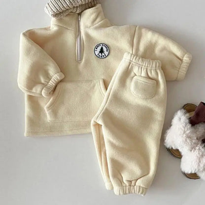 Toddler in a comfortable unisex knit set, long sleeve turtleneck sweater & matching pants.