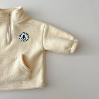 Baby wearing a soft gray knit sweater and pants set, ideal for cold weather.