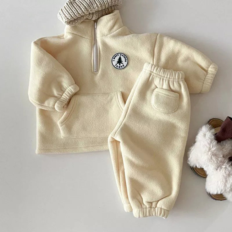 Full view of a unisex knit sweater set for kids, long sleeve top and matching bottoms.