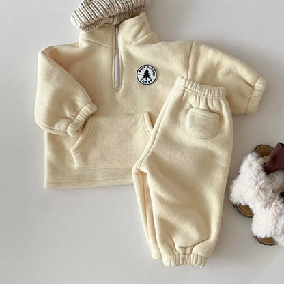 Full view of a unisex knit sweater set for kids, long sleeve top and matching bottoms.