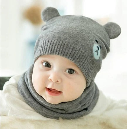 Baby fashion: Toddler wearing a stylish knitted hat and scarf set, perfect for winter outings