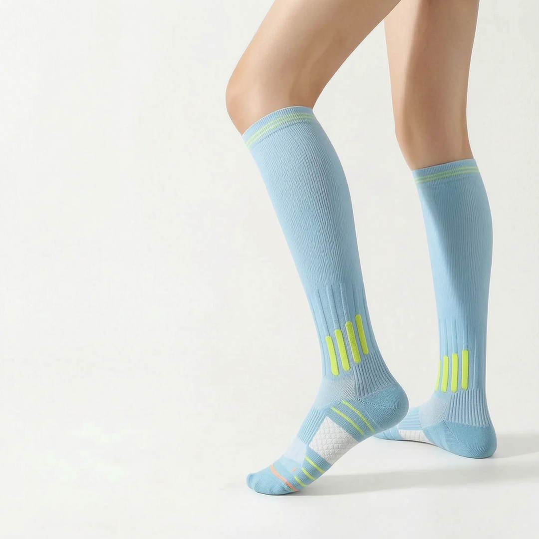 Durable white athletic socks, knee-high, providing support for sports activities.