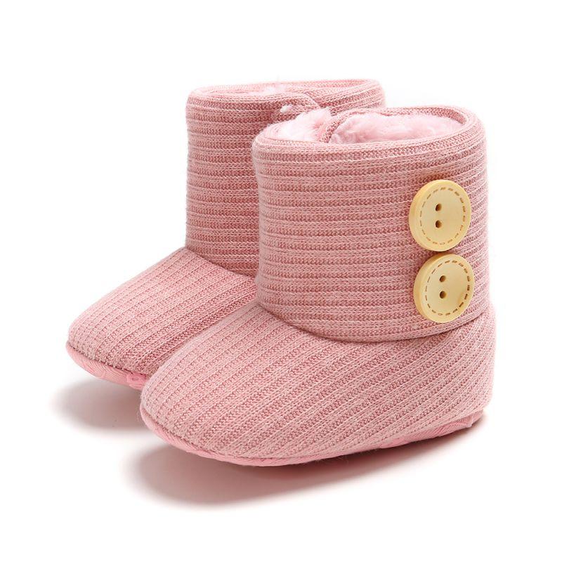 Pair of knitted baby boots with velcro closure, anti-slip sole, cozy infant footwear.