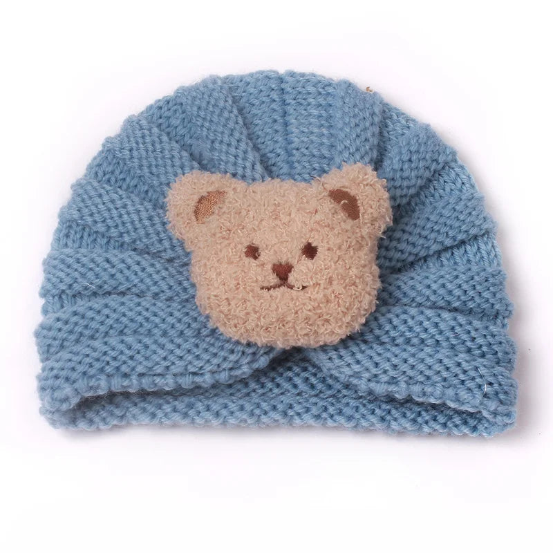 Baby's first winter adventure wearing a warm knitted candy color beanie, cozy headwear