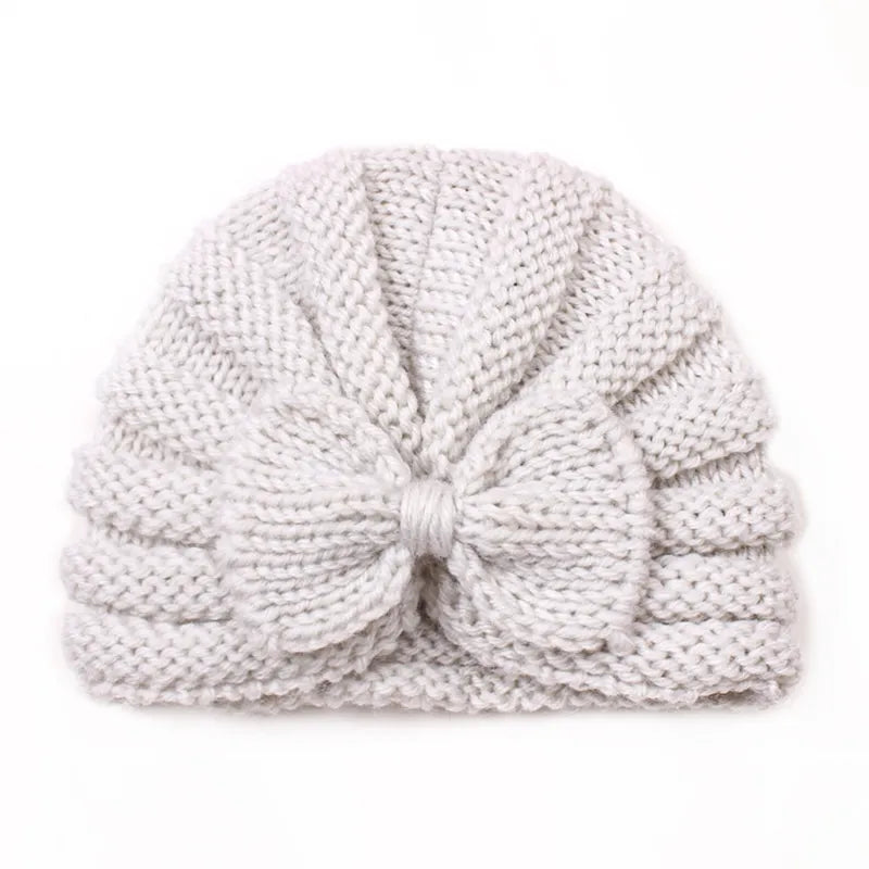 Baby's outfit completed with a cheerful knitted candy color hat, adorable winter style