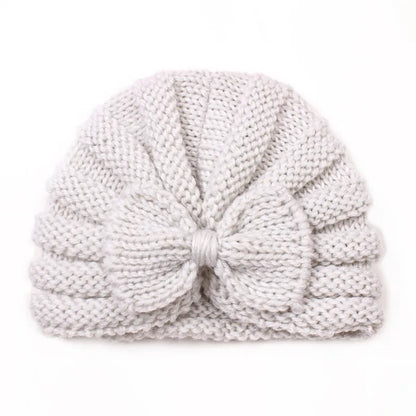 Baby's outfit completed with a cheerful knitted candy color hat, adorable winter style