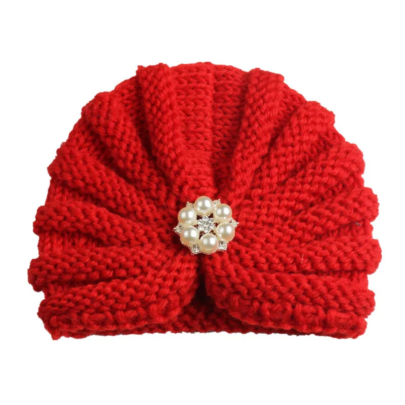 Detailed texture of a knitted candy color baby beanie, soft fabric for baby's head