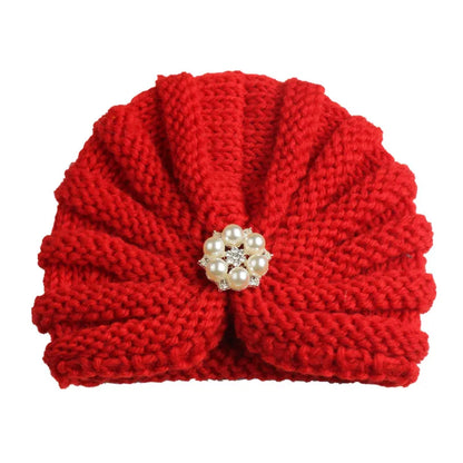 Detailed texture of a knitted candy color baby beanie, soft fabric for baby's head