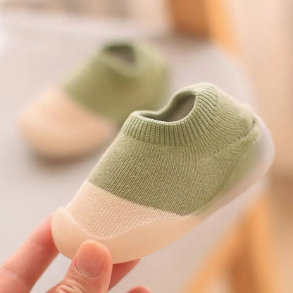 Unisex knitted baby boots in a neutral color, non-slip support for toddlers.