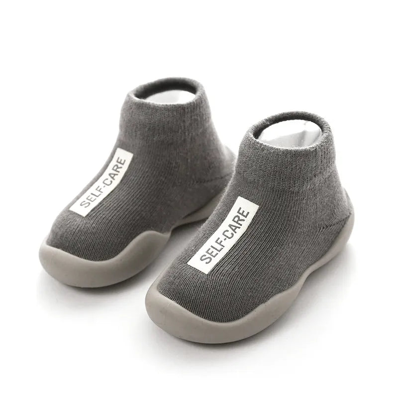 Infant footwear: unisex knitted baby first walker boots with grippy sole.