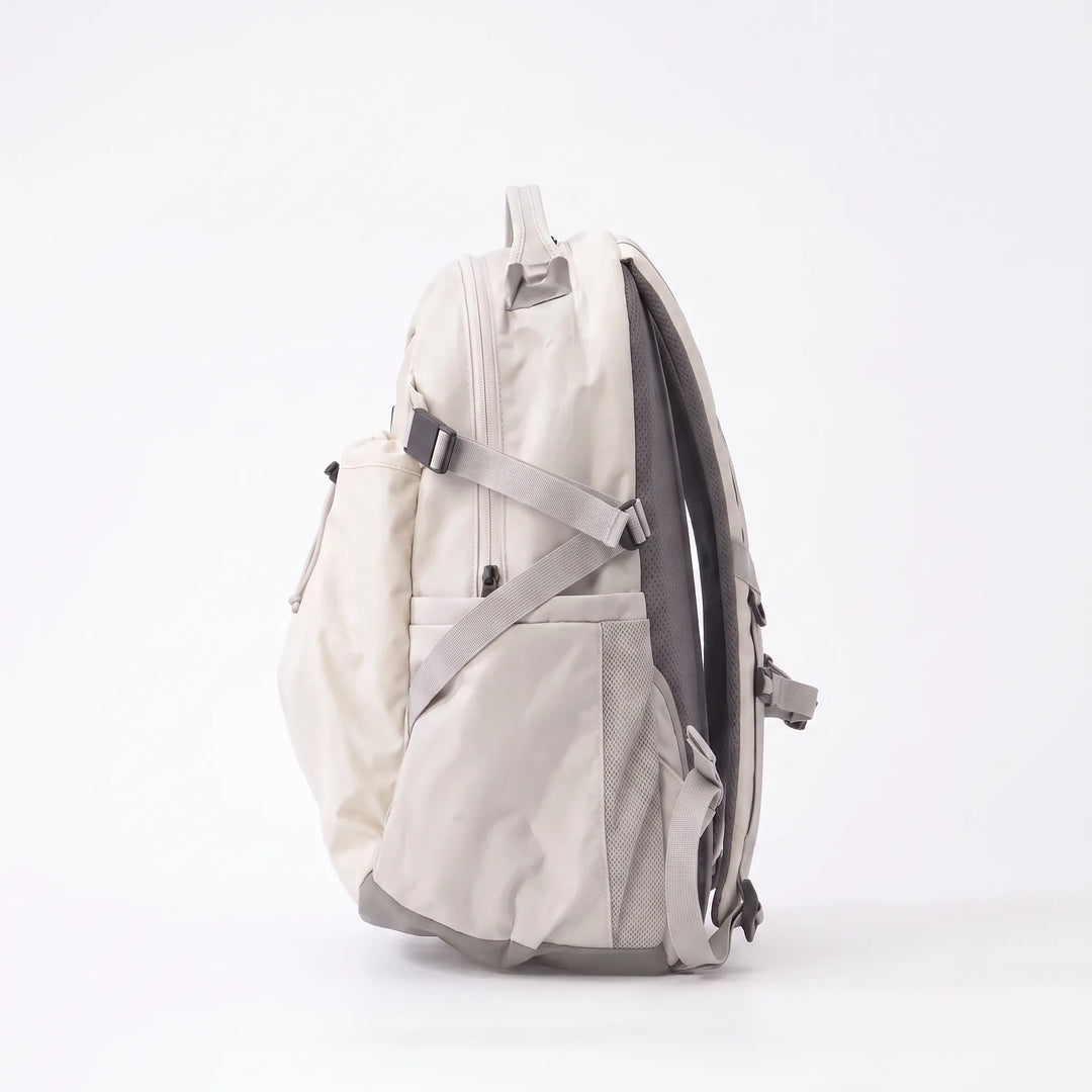 Large capacity hiking backpack resting by a scenic lake, ready for camping, day trips, and rugged outdoor adventures.