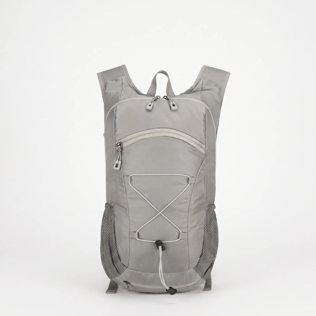 Unisex lightweight hiking backpack worn by a hiker on a scenic trail, great for day trips.