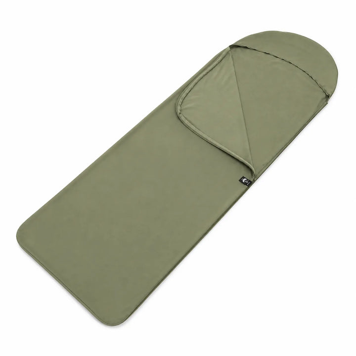 Person zipping up a lightweight rectangular sleeping bag liner inside a tent for comfortable camping hygiene.