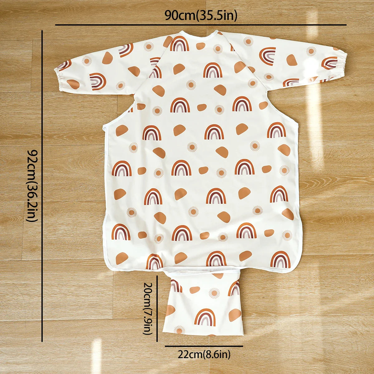 Toddler long sleeve waterproof feeding bib with food-catching pocket, vibrant pattern, easy clean.