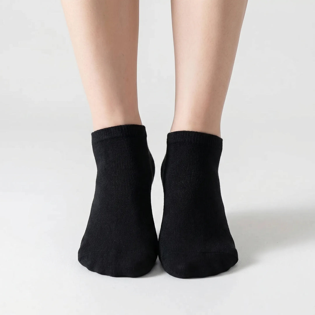Neatly folded bulk pack of gray unisex low-cut ankle socks, offering everyday comfort & versatile style.
