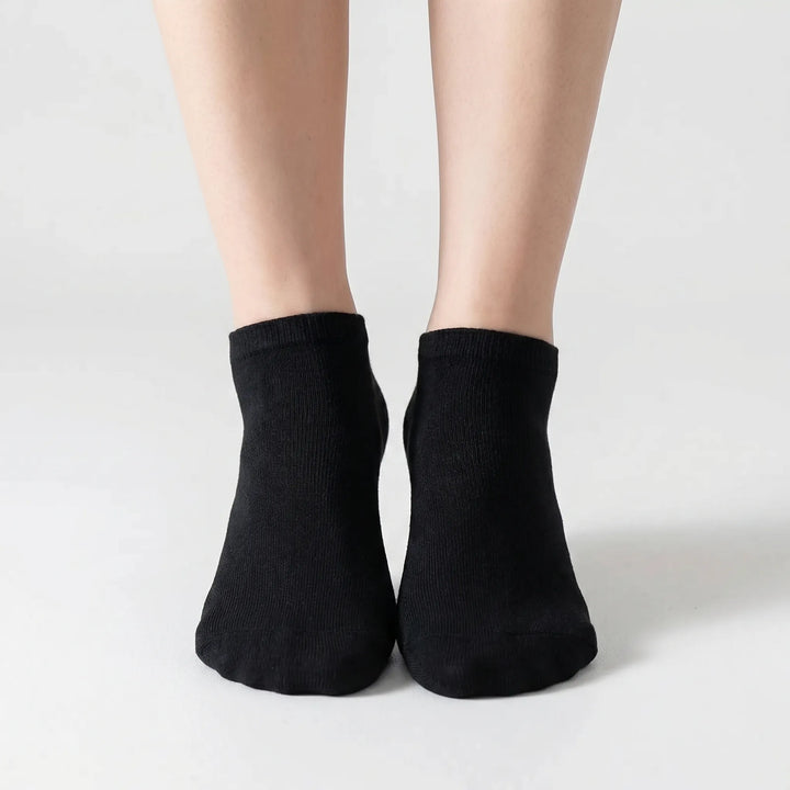 Neatly folded bulk pack of gray unisex low-cut ankle socks, offering everyday comfort & versatile style.